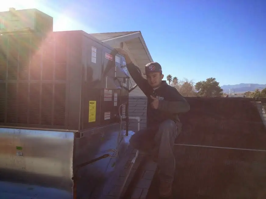 HVAC technician performing Heat Pump Repair on a rooftop unit in San Juan Capistrano